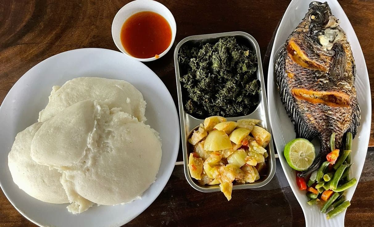 A serving of thick white maize meal beside a bowl of relish